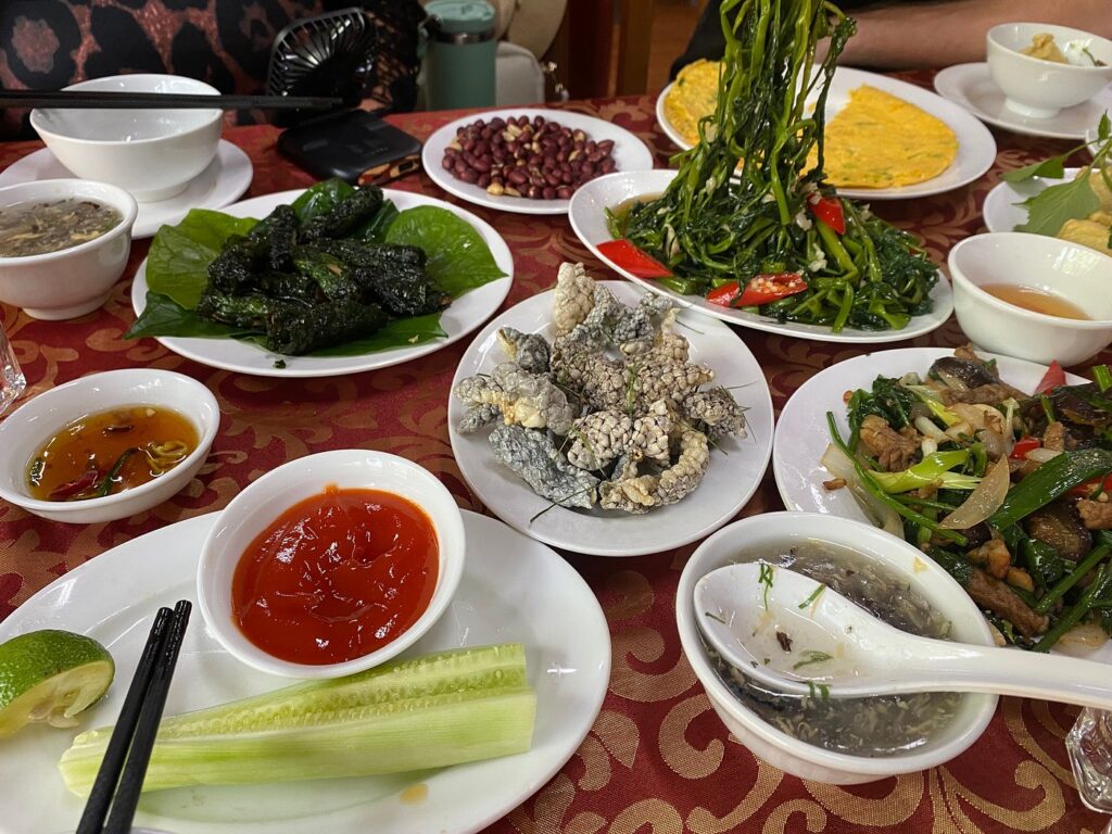 Snake dishes, vegetables and soup served together at a Le Mat Village restaurant.